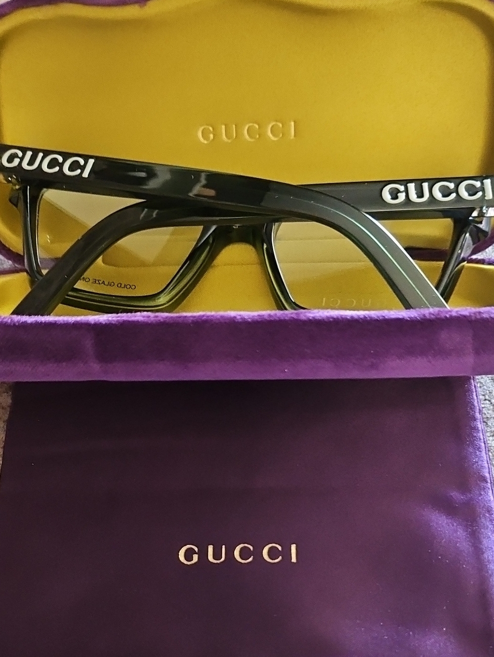 Gucci Black frame with Yellow Case and Purple Pouch.